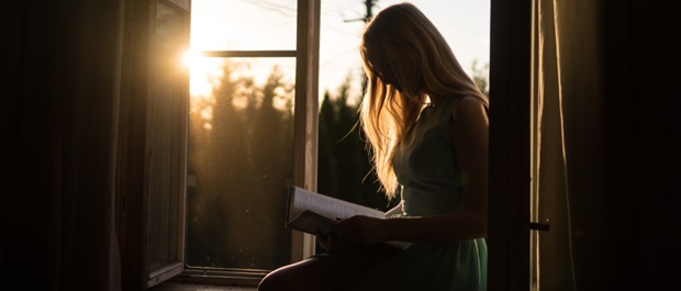 Woman reading in window