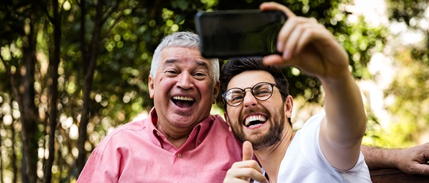 Adult father and son taking a selfie