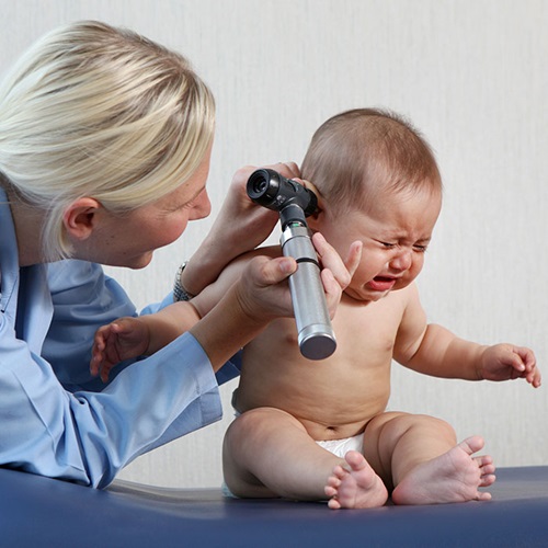 doctor checking baby ears