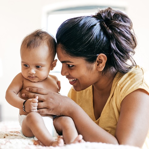 Mother holding her happy healthy baby.