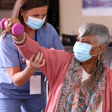 Older woman receiving therapy after a stroke.