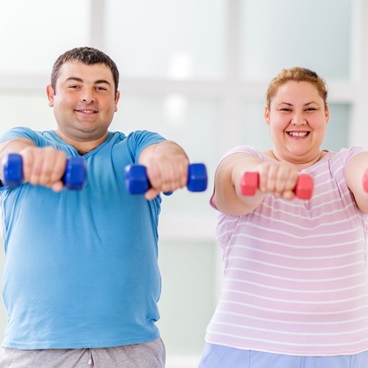man and woman exercising with weights