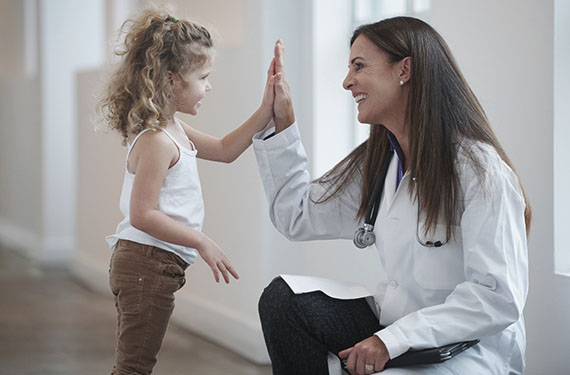 doctor giving young girl high five